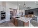 Open kitchen with a large island, modern appliances, and a decorative pantry door, seamlessly connected to living spaces at 4289 W Caribou Ln, Queen Creek, AZ 85142