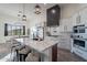 Modern kitchen with large island, white cabinets, stainless steel appliances, and open to a breakfast area with hill views at 4289 W Caribou Ln, Queen Creek, AZ 85142