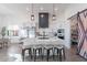 Open-concept kitchen with a large island, white cabinets, stainless steel appliances, and pantry with a decorative barn door at 4289 W Caribou Ln, Queen Creek, AZ 85142