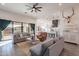 Open concept living room featuring hardwood floors, comfortable seating, and a seamless transition to the kitchen area at 4289 W Caribou Ln, Queen Creek, AZ 85142