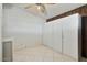 View of bedroom with tile flooring, built-in storage, and a ceiling fan at 4415 W Laurie Ln, Glendale, AZ 85302