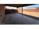 An angled view of the covered patio, overlooking the backyard with its privacy fence at 4621 N 47Th Dr, Phoenix, AZ 85031
