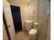 Bathroom with a glass shower, toilet, and vanity sink, adjacent to bedroom at 4621 N 47Th Dr, Phoenix, AZ 85031