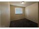 Bedroom with a window allowing natural light and carpeted flooring at 4621 N 47Th Dr, Phoenix, AZ 85031