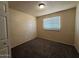 Bedroom features a window letting in light, carpeted floors, and neutral brick walls at 4621 N 47Th Dr, Phoenix, AZ 85031