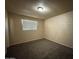 Bedroom with carpeted flooring, neutral walls, and a window at 4621 N 47Th Dr, Phoenix, AZ 85031
