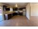 Modern kitchen with stainless steel appliances, dark cabinets, and tile flooring at 4621 N 47Th Dr, Phoenix, AZ 85031