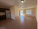 Open-concept living area featuring tile floors, natural light, and convenient kitchen access at 4621 N 47Th Dr, Phoenix, AZ 85031