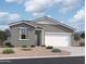 Charming single-story home featuring a two-car garage, neutral stucco, and desert landscaping at 47747 W Moeller Rd, Maricopa, AZ 85139