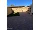Enclosed backyard featuring brick pavers, artificial turf, and a wooden fence at 4845 W Marlette Ave, Glendale, AZ 85301