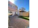 Enclosed backyard featuring brick pavers, artificial turf, and a covered patio at 4845 W Marlette Ave, Glendale, AZ 85301