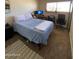 Bedroom featuring a bed with a light blue comforter, a workspace, and natural lighting at 4845 W Marlette Ave, Glendale, AZ 85301