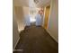 Upstairs hallway with carpet and doorway views to bedroom with natural light at 4845 W Marlette Ave, Glendale, AZ 85301