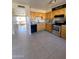 Spacious kitchen with wood cabinets, stainless steel appliances, and tile flooring at 4845 W Marlette Ave, Glendale, AZ 85301