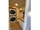 Laundry room with a stacked washer and dryer unit and a white vanity at 4845 W Marlette Ave, Glendale, AZ 85301