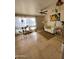 Inviting living room with tile floors, ceiling fan, a white sofa and many plants at 4845 W Marlette Ave, Glendale, AZ 85301