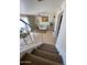 Open-concept view from the stairs shows the bright living room with tile floors and lots of plants at 4845 W Marlette Ave, Glendale, AZ 85301