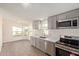 Open kitchen with stainless steel appliances and modern gray cabinetry at 537 S 97Th St, Mesa, AZ 85208