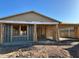New construction home featuring a framed exterior with a covered porch and the framework for future windows at 5521 W Paseo Way, Laveen, AZ 85339
