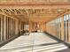 Spacious, unfinished garage interior showcasing the stud framing and concrete floor at 5521 W Paseo Way, Laveen, AZ 85339