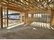 Framed interior space of the home showcases a concrete floor, wood framing, and view of the home next door at 5521 W Paseo Way, Laveen, AZ 85339