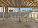Framed interior of an unfinished room showing concrete flooring and partial view of the block wall at 5521 W Paseo Way, Laveen, AZ 85339