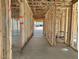 Spacious interior view displaying the framed walls and flooring of this new construction home at 5521 W Paseo Way, Laveen, AZ 85339
