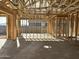 Unfinished room showcasing the framed walls, open ceiling, and concrete floors of this new home at 5521 W Paseo Way, Laveen, AZ 85339