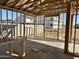 Unfinished living room displays framed walls, concrete floors, and view of neighboring homes at 5521 W Paseo Way, Laveen, AZ 85339