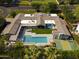 Luxury home boasts a private backyard oasis with a pool, outdoor dining, and a sports court for entertainment at 6301 E Exeter Blvd, Scottsdale, AZ 85251