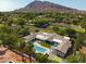 Expansive estate showcasing a large pool, sports court, and a mountain backdrop, perfect for luxurious outdoor living at 6301 E Exeter Blvd, Scottsdale, AZ 85251