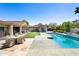 Expansive backyard with a pool, patio dining set, and lush landscaping at 6301 E Exeter Blvd, Scottsdale, AZ 85251