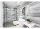 Modern bathroom featuring a glass shower, round mirror, and stylish marble wall at 6301 E Exeter Blvd, Scottsdale, AZ 85251