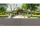 Beautifully landscaped front yard and modern home exterior with large windows at 6301 E Exeter Blvd, Scottsdale, AZ 85251