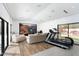 Bright gym with a treadmill, sofa, and access to the backyard at 6301 E Exeter Blvd, Scottsdale, AZ 85251
