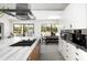 Bright kitchen with marble island, built-in appliances and view to outdoor patio at 6301 E Exeter Blvd, Scottsdale, AZ 85251