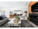 Open living space with modern fireplace, stylish decor and open kitchen at 6301 E Exeter Blvd, Scottsdale, AZ 85251