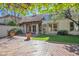 Outdoor view featuring a stone patio, grass lawn, manicured landscaping, and balcony at 6701 N Scottsdale Rd # 23, Scottsdale, AZ 85250