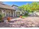 Outdoor view featuring a stone patio, grass lawn, manicured landscaping, and an upper balcony at 6701 N Scottsdale Rd # 23, Scottsdale, AZ 85250