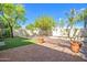 Outdoor view featuring a stone patio, lawn, manicured landscaping, and privacy fence at 6701 N Scottsdale Rd # 23, Scottsdale, AZ 85250