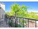 Charming balcony with wrought iron railing and views of lush greenery and blue skies at 6701 N Scottsdale Rd # 23, Scottsdale, AZ 85250