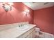 Bathroom featuring wallpaper, sink with a tile countertop, and tiled floors at 6701 N Scottsdale Rd # 23, Scottsdale, AZ 85250