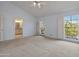 Large bedroom featuring carpet, access to a balcony, and a ceiling fan at 6701 N Scottsdale Rd # 23, Scottsdale, AZ 85250