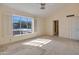 Bright bedroom featuring a vaulted ceiling, neutral carpet, a ceiling fan and a large window at 6701 N Scottsdale Rd # 23, Scottsdale, AZ 85250