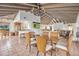 Open dining room showcases tile flooring, wood beam ceiling, and seamless transition to the living and kitchen areas at 6701 N Scottsdale Rd # 23, Scottsdale, AZ 85250