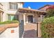 Inviting front entrance featuring a charming brick path, stucco walls, and wrought iron details at 6701 N Scottsdale Rd # 23, Scottsdale, AZ 85250