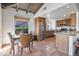 Bright, open kitchen features wood cabinets, stainless steel appliances, granite countertops, and eat-in dining space at 6701 N Scottsdale Rd # 23, Scottsdale, AZ 85250