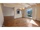 Bright living room with hardwood floors, chandelier, and access to outdoor courtyard at 6701 N Scottsdale Rd # 23, Scottsdale, AZ 85250