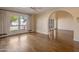Bright living room with hardwood floors, glass doors to the backyard, and an archway at 6701 N Scottsdale Rd # 23, Scottsdale, AZ 85250