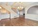 Spacious living room features hardwood floors, fireplace, chandelier, and wet bar at 6701 N Scottsdale Rd # 23, Scottsdale, AZ 85250
